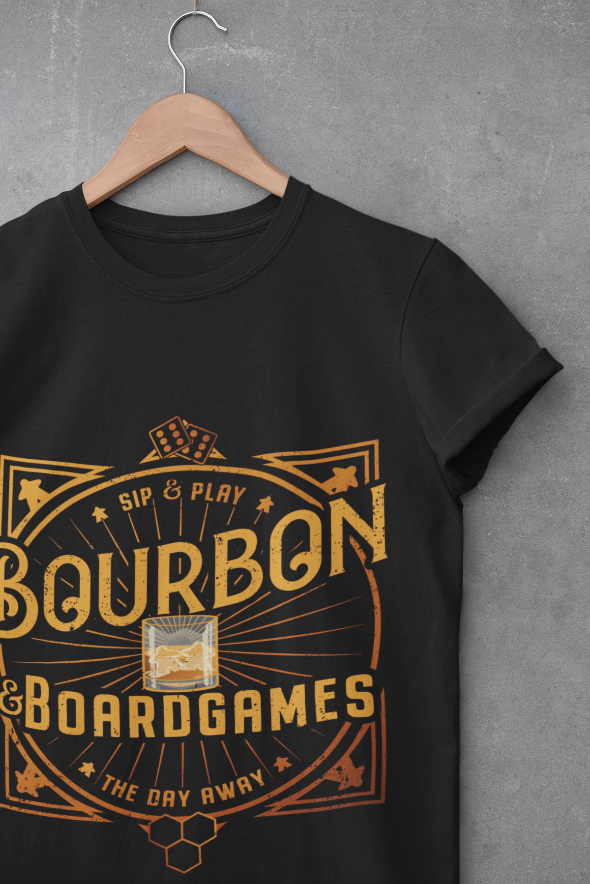 Black t-shirt with 'Bourbon & Boardgames' design on a hanger against a gray background