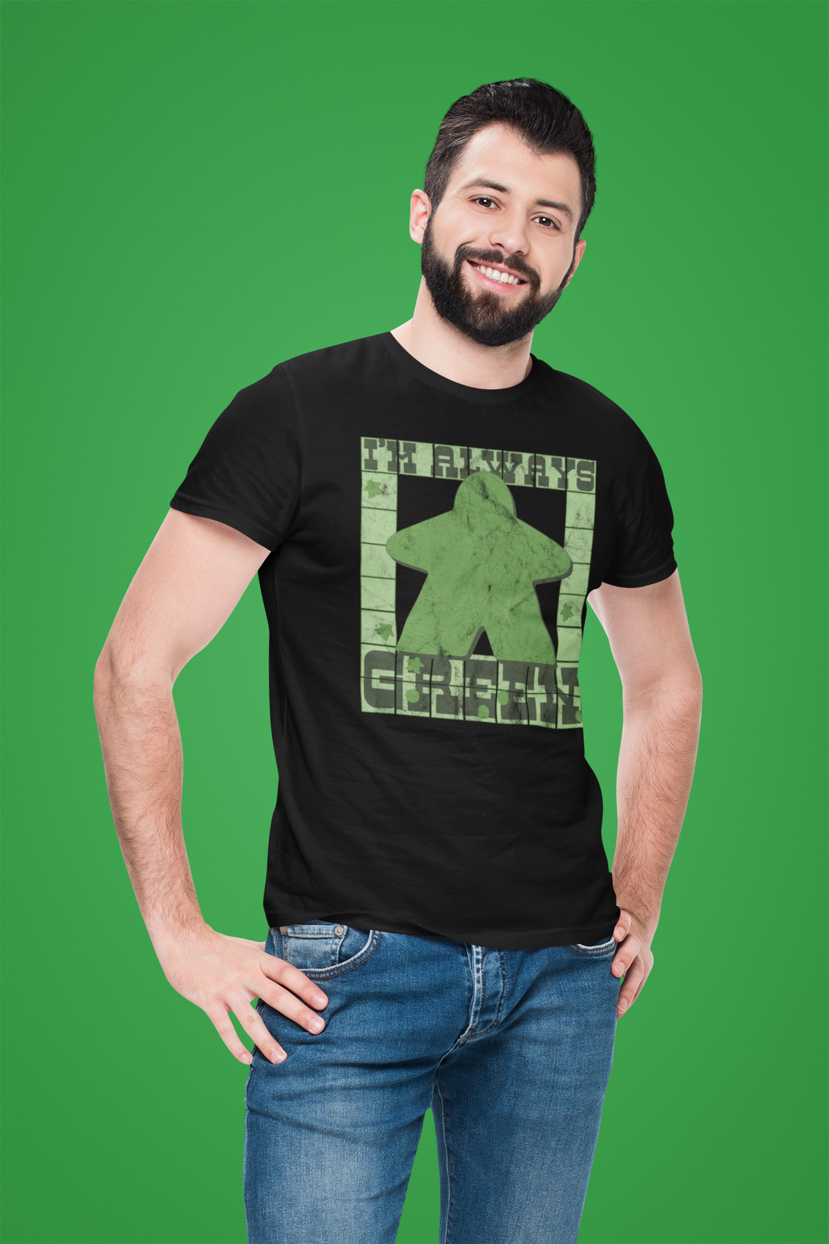 Man wearing a black t-shirt with a graphic design on a green background