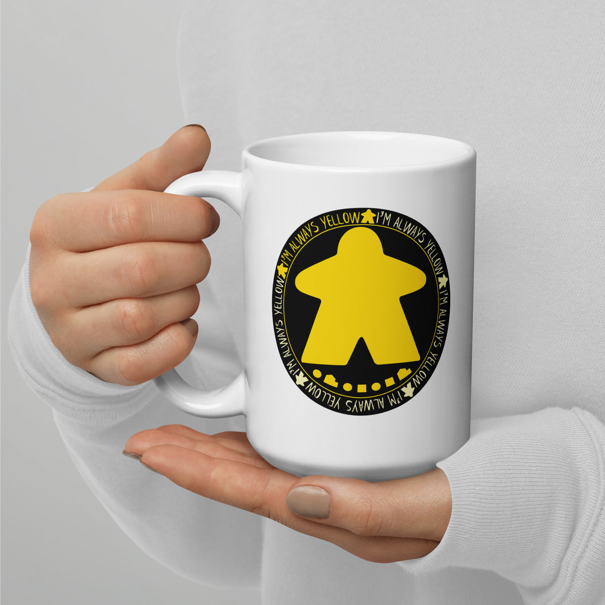 Woman's hands holding a ceramic coffee mug with our I'm Always Yellow design printed on it