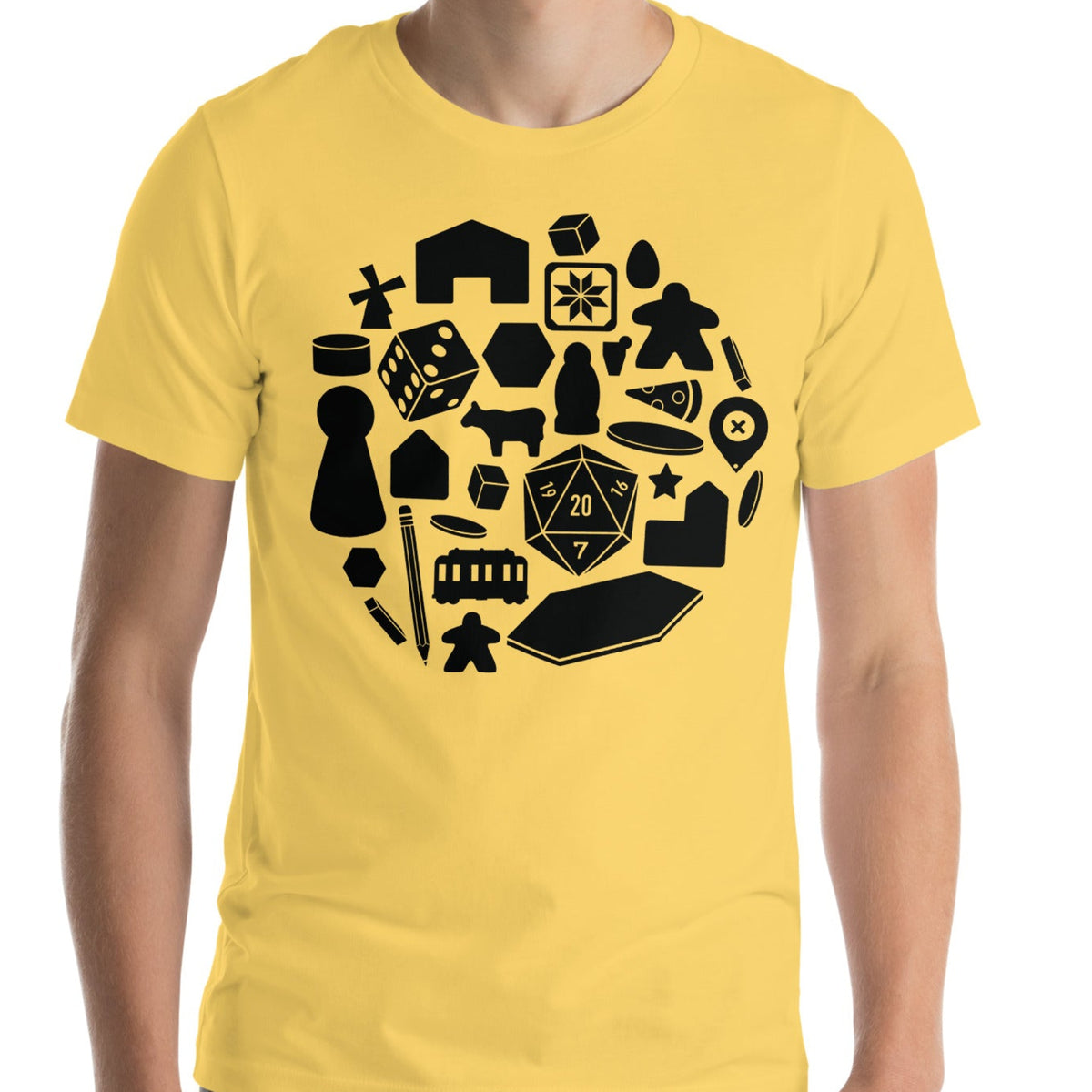Yellow t-shirt worn by. model with our board game pieces design printed on the front