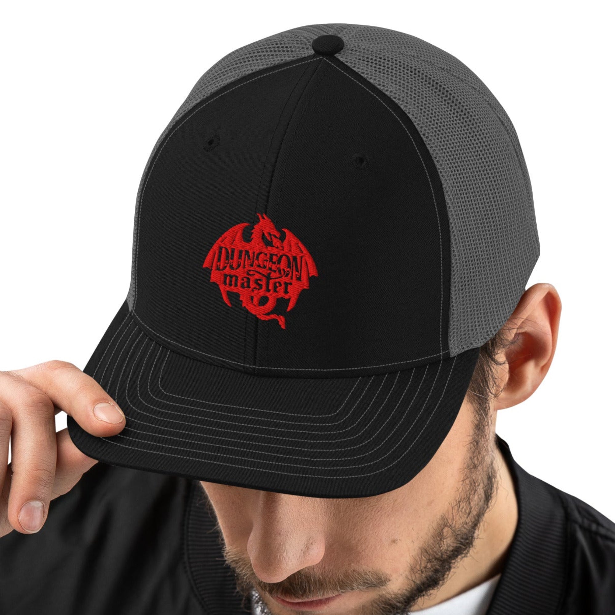 Model wearing black and grey hat with our Dungeon Master Dragon design embroidered on the front