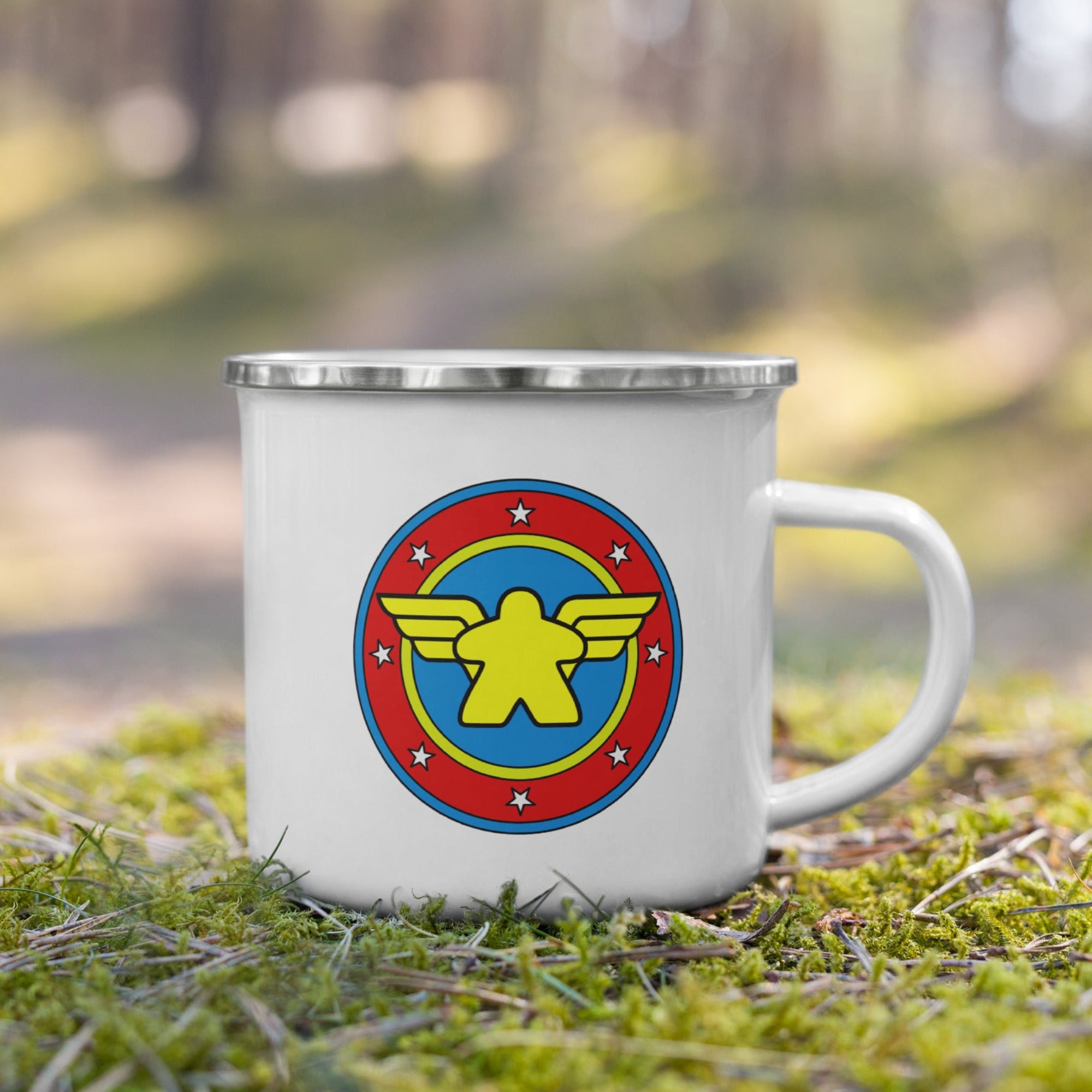 Enamel Camping Mug in the woods with our Wonder Meeple design printed on it.