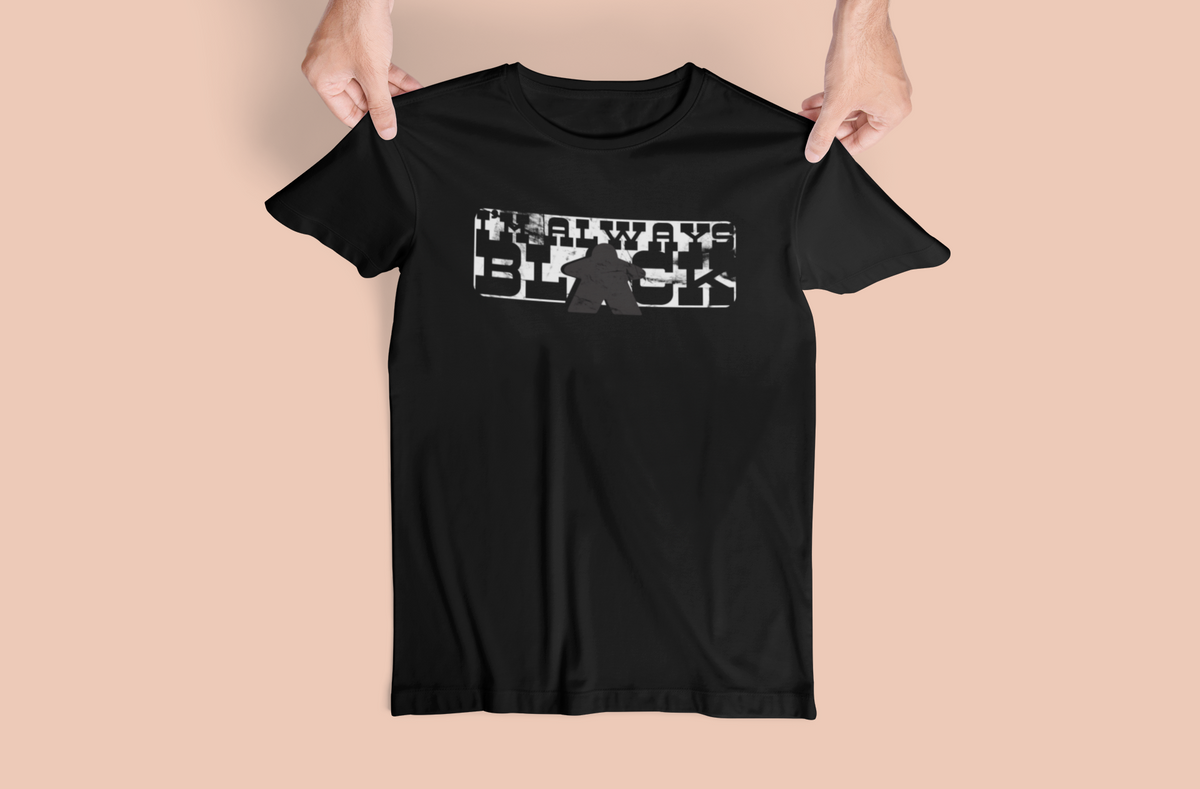 Black t-shirt with our I'm Always Black design design held by a person on a beige background