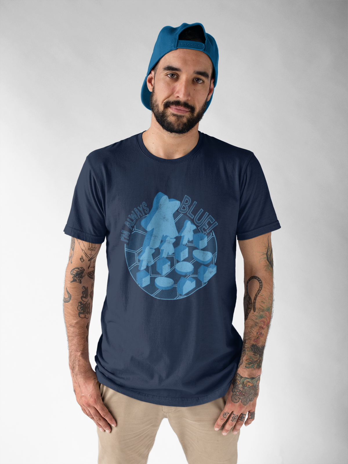 Man wearing a navy t-shirt with our i'm always blue design on a gray background