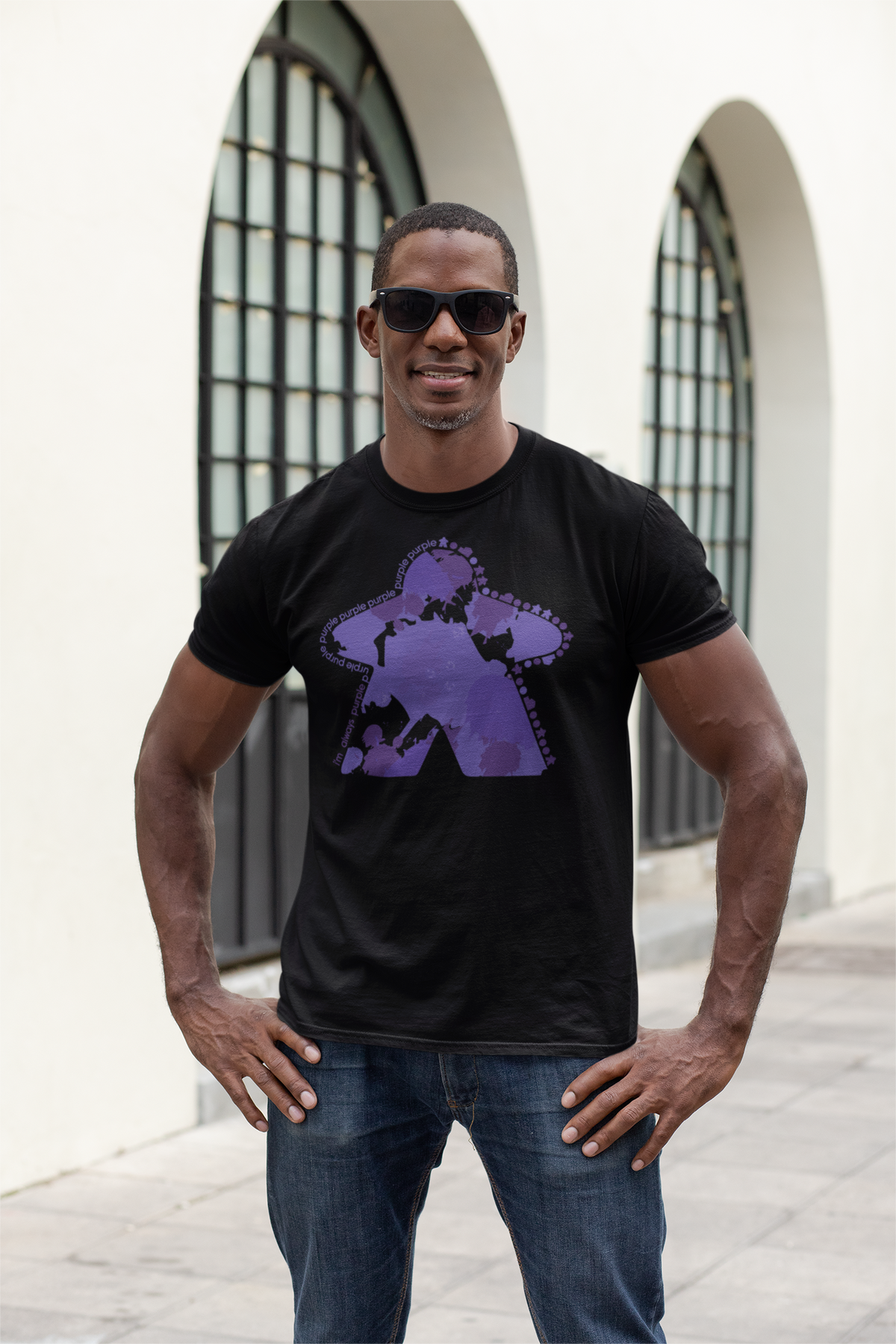 Man wearing a black t-shirt with our  I'm Always Purple graphic design outdoors.