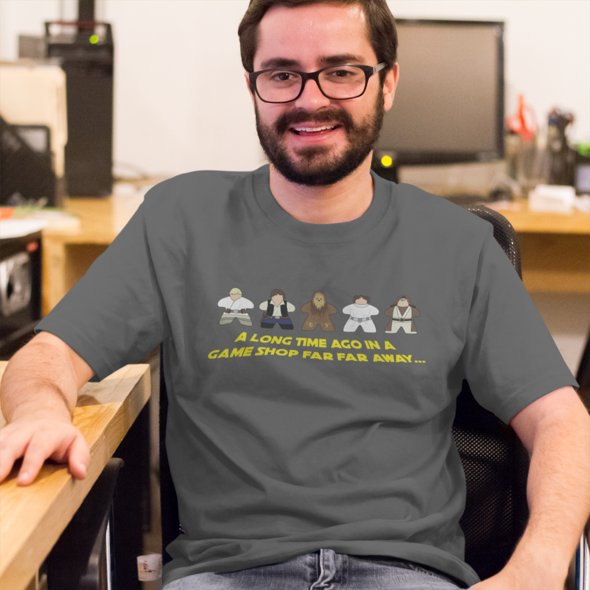 Man sitting at desk with our Long Time Ago in a Game Shop Far Way Star Wars Parody T-Shirt