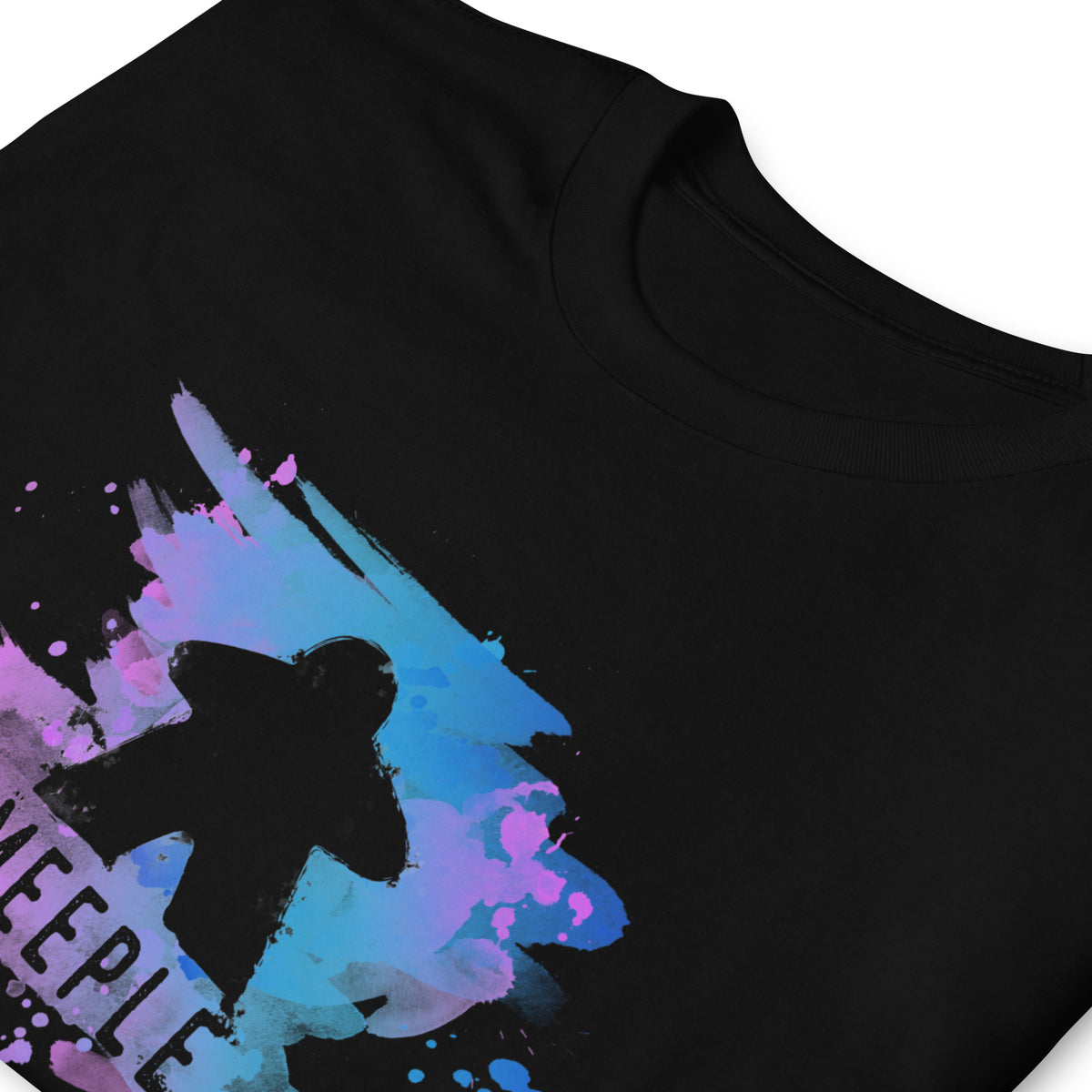 Black folded t-shirt on a white background with our meeple splash design printed on it