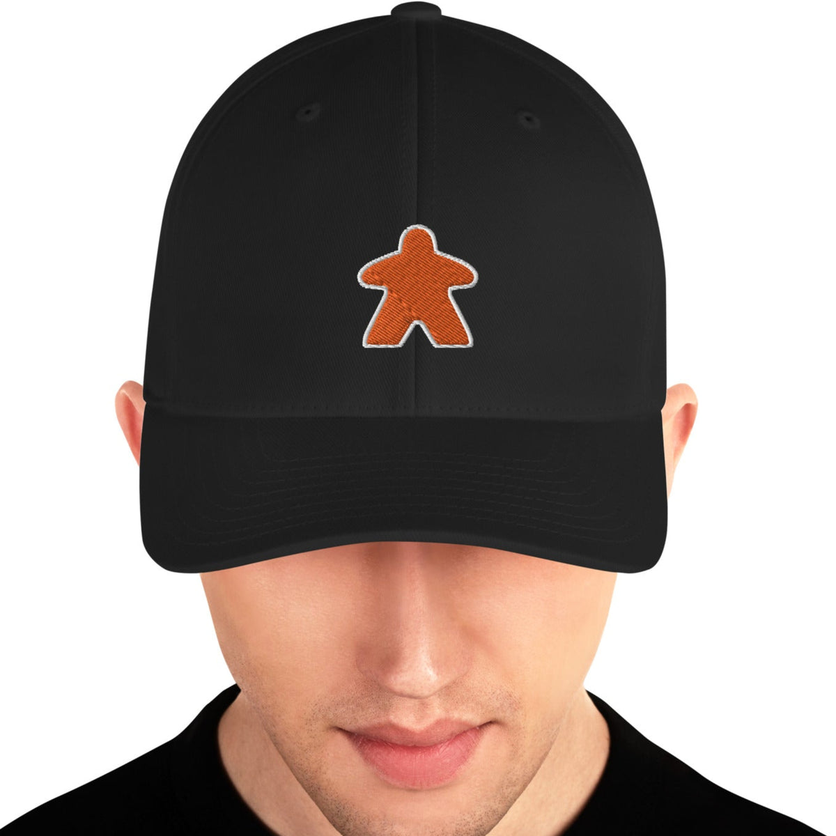 Black hat worn by a man with an embroidered orange meeple on the front