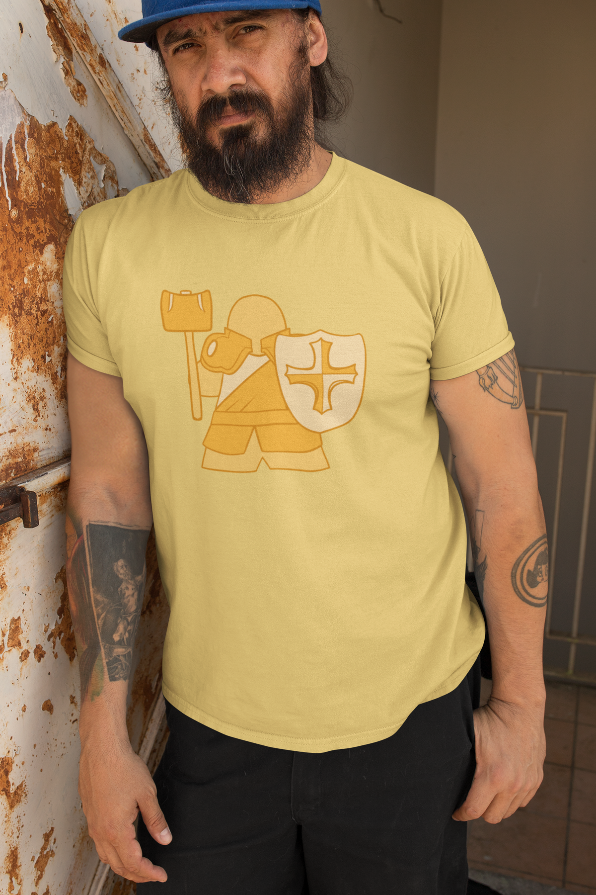 Man leaning against wall wearing our D&D Paladin Meeple T-Shirt