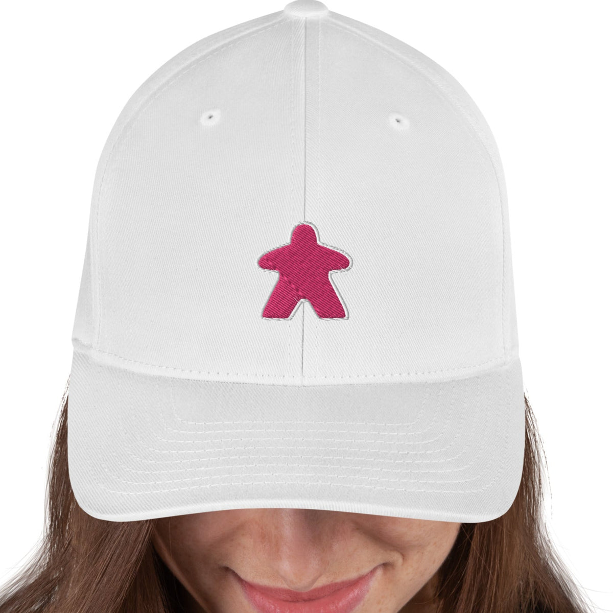 White flexfit board game hat with our pink meeple design embroidered on the front