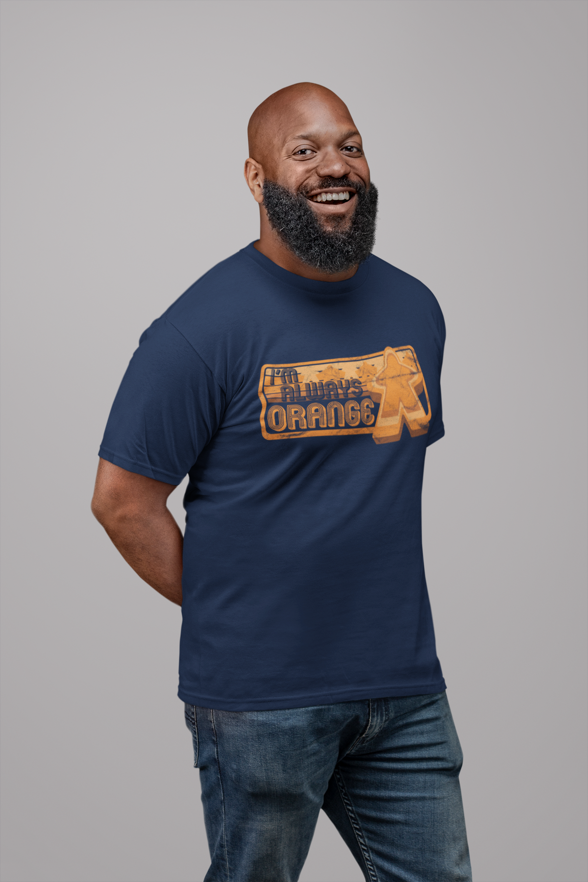 Man wearing a navy blue t-shirt with our I'm Always Orange design on a gray background