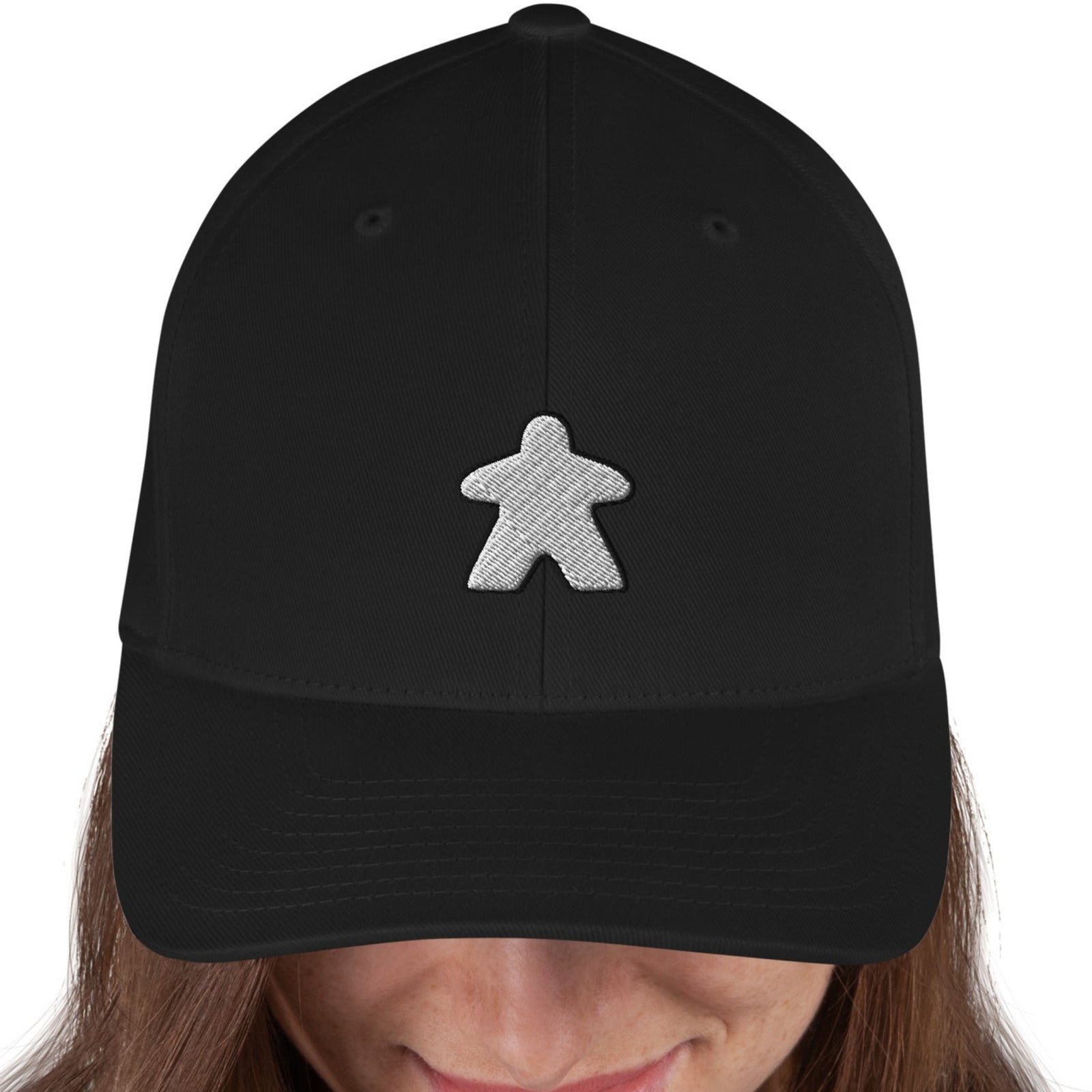 White meeple design embroidered on a black flexfit baseball cap