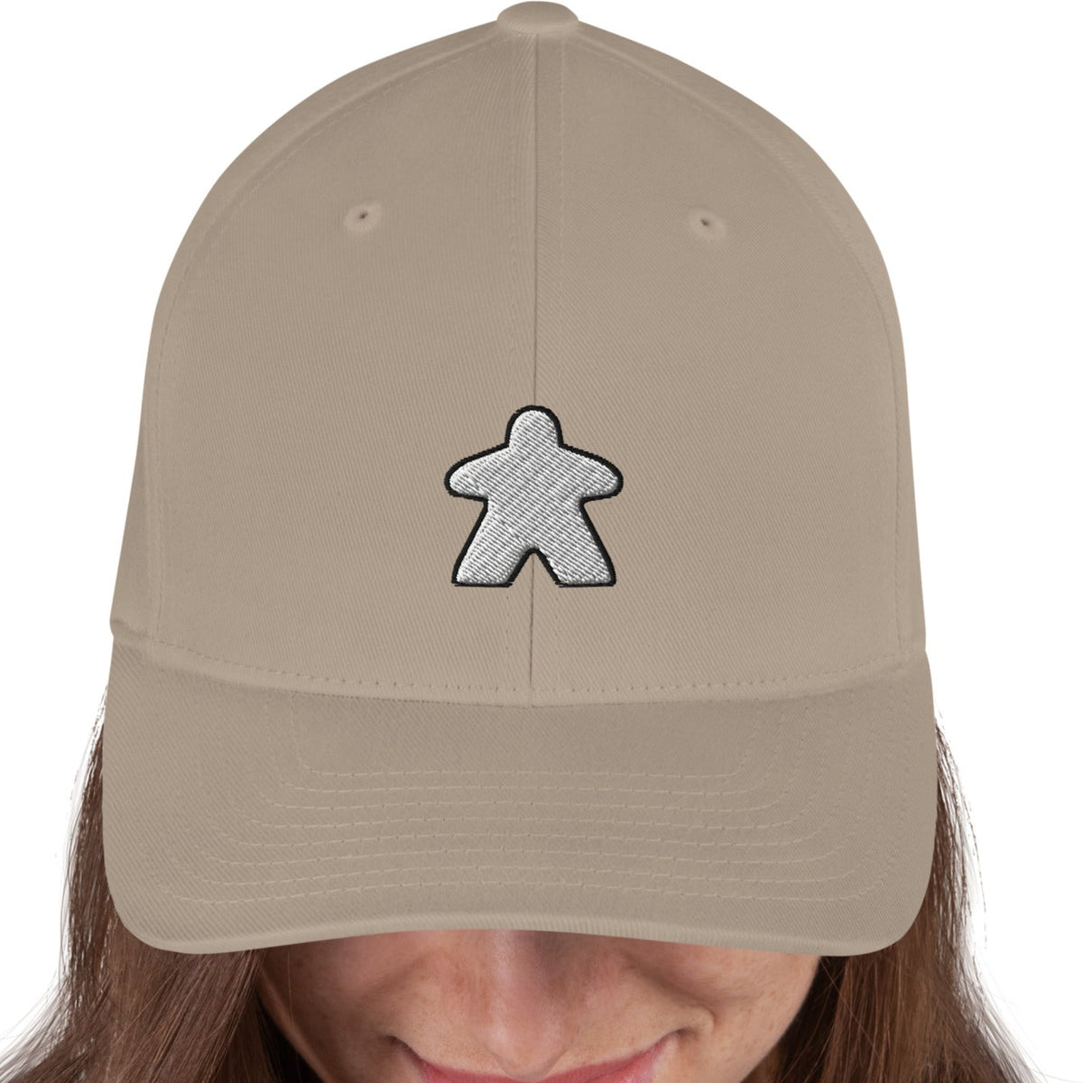 white meeple design embroidered on a tan flexfit baseball cap